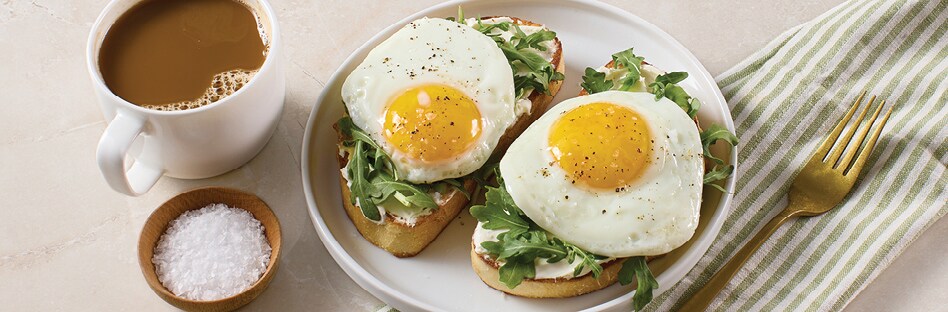 Toasted sourdough with cream cheese, fresh arugula, a perfectly fried egg and a sprinkle of flaky sea salt.