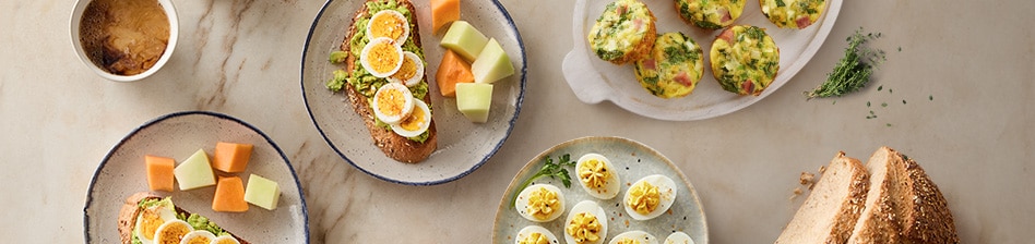 Serving platters with deviled eggs, quiches, and avocado toast.