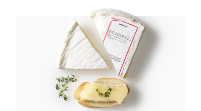 Brie cheese triangles on white surface with thyme garnish