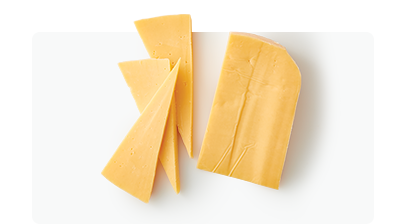 Gouda cheese block and slices on white surface