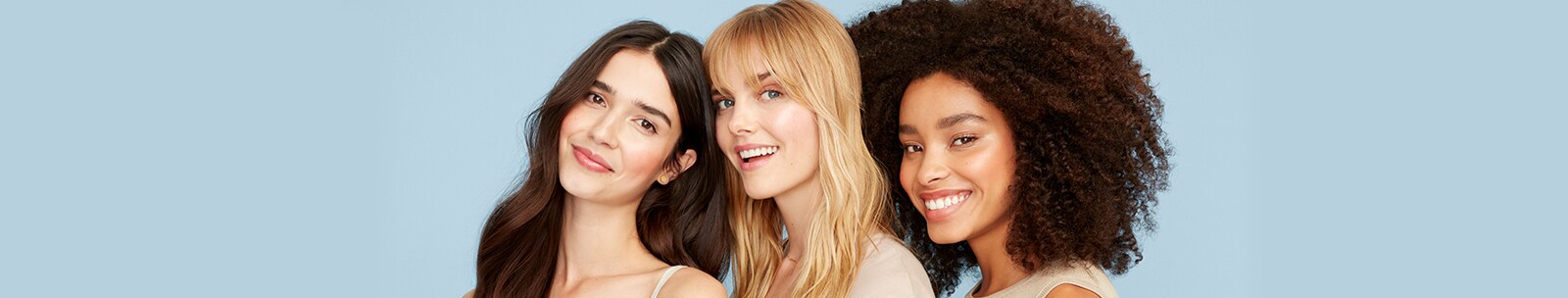Three diverse women with healthy skin standing side by side