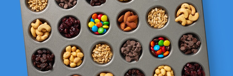classic trail mix ingredients in muffin tin