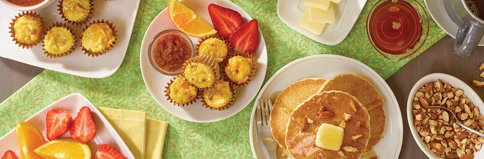 spread of assorted breakfast dishes on tablescape with flowers