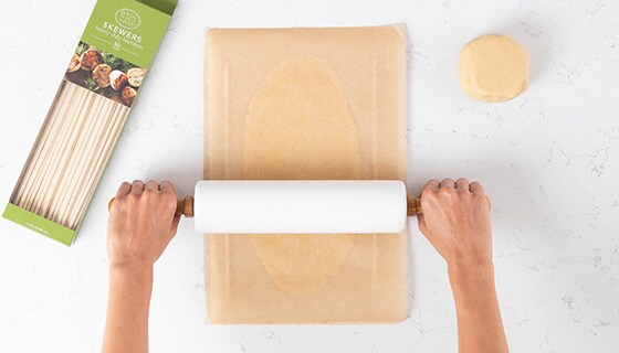 Rolling dough between parchment paper