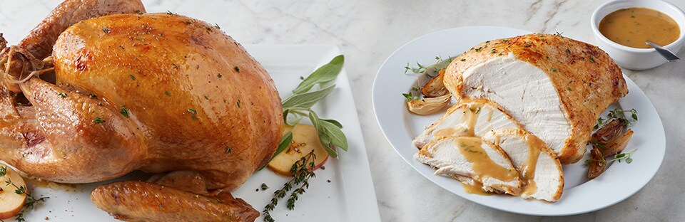 Two roasted turkeys displayed on marble background to show turkey brining done in multiple ways.