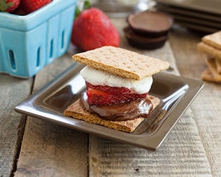 Jelly filled smore on silver plate on a wooden table Jelly filled smore on silver plate on a wooden table