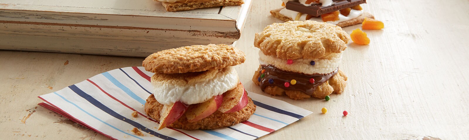 Homemade apple cinnamon and peanut butter banana s’mores on a striped napkin Homemade apple cinnamon and peanut butter banana s’mores on a striped napkin