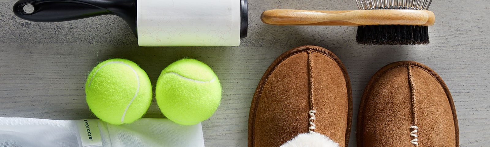 A pair of slippers, tennis balls, lent roller, and brush to take care of your wardrobe