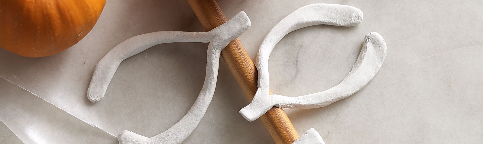 Clay wishbones on wooden spoon