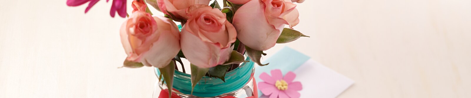 Decorated mason jar filled with pale pink roses Decorated mason jar filled with pale pink roses